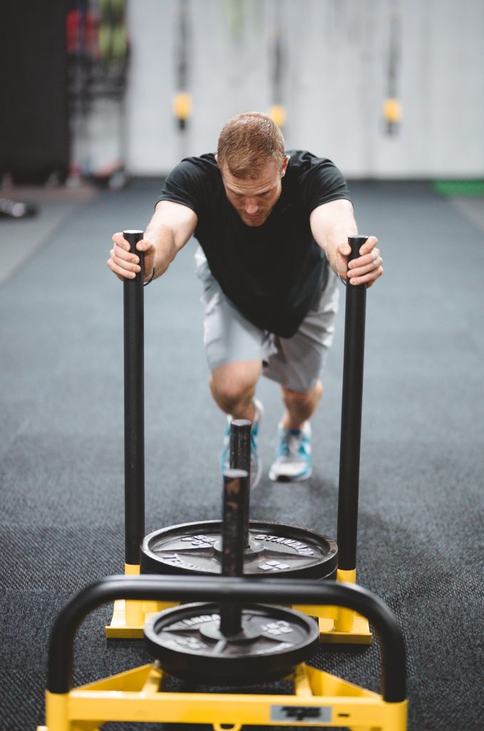 Athlete pushing weighted sled