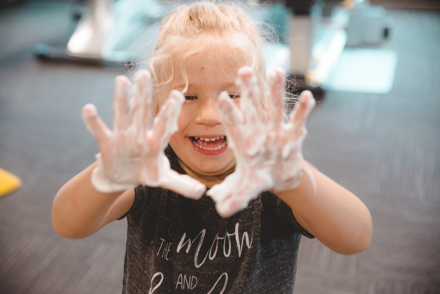 child with shaving cream on hands