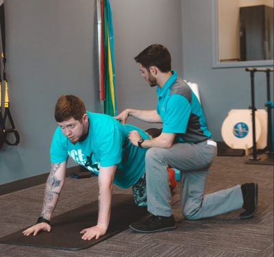 Therapist working on floor with patient