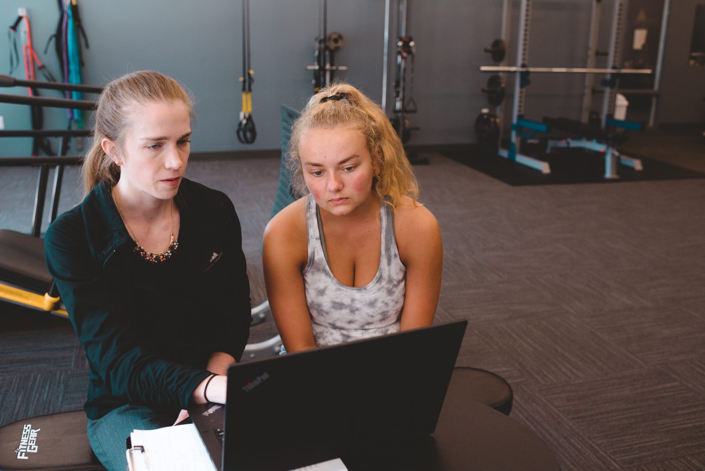 Therapist talking with patient by a computer