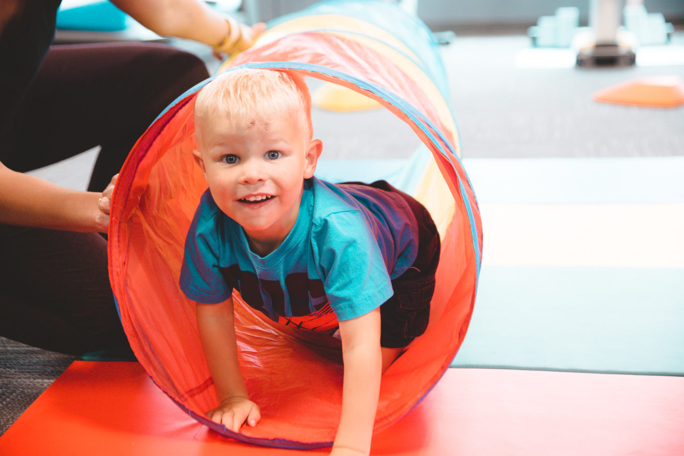 Boy climbing through tunnel