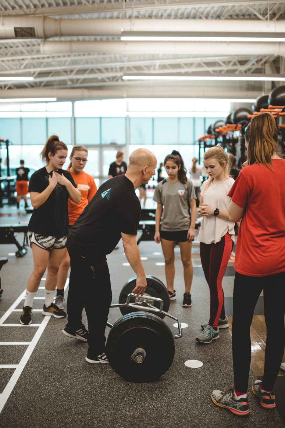 Strength coach talking to athletes