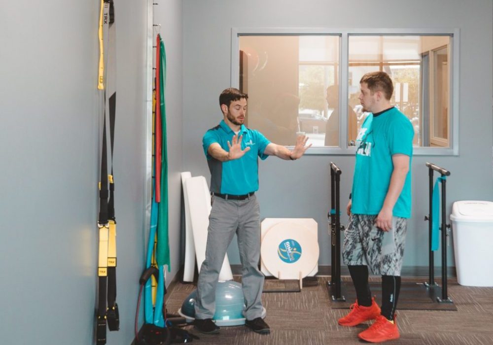 Therapist showing patient an exercise